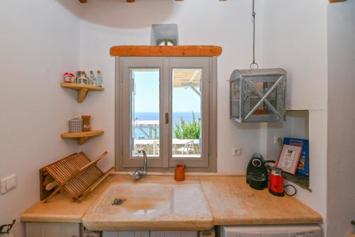 a kitchen with a sink and a window at Dream summer house in Tinos in Tinos Town