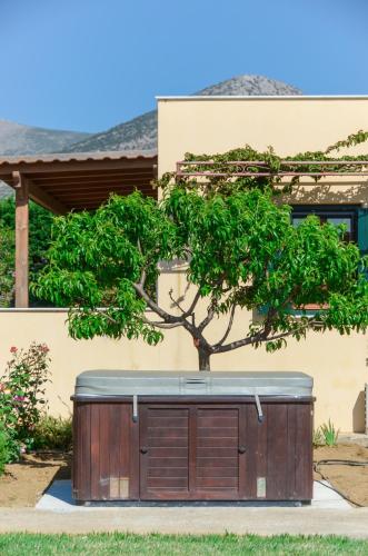 a garage with a tree in front of a house at Naxos Cottage in Káto Sangríon