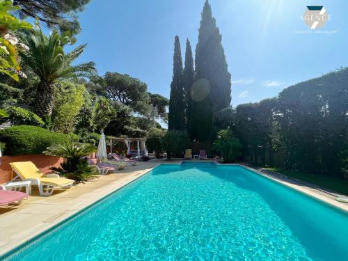- une piscine dans une villa avec des palmiers dans l'établissement Villa Pura Vida, à Sainte-Maxime
