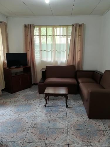 a living room with a couch and a coffee table at Apartamento Lopez y Azofeifa in Portete