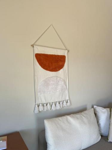 a towel hanging on a wall above a couch at Sueño in Taktikoúpolis