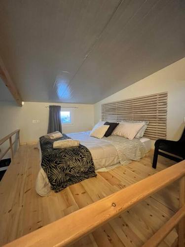 a bedroom with a large bed and a wooden floor at Sueño in Taktikoúpolis