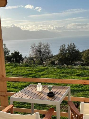 a table on a deck with a view of the water at Sueño in Taktikoúpolis