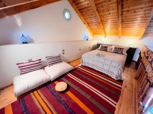 a bedroom with two beds and a rug at Blue Horizon Kastellorizo in Meyisti