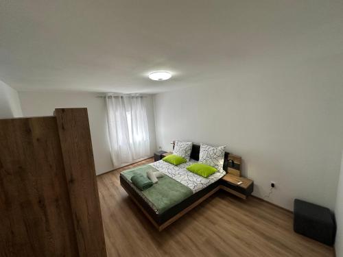 a bedroom with a bed with green pillows at Mimi&Nina in Prović
