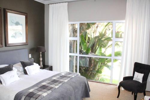 a bedroom with a bed and a large window at Muller's Self Catering - a cozy home from home! in Swakopmund