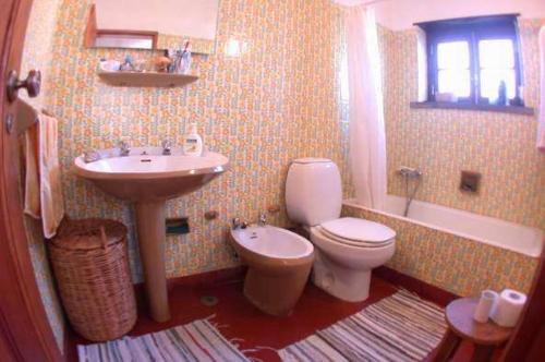 a bathroom with a sink and a toilet and a sink at CASA DAS PONTES in Ribamar