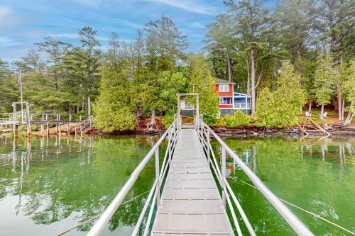 a bridge over the water with a house in the background at Rockhaven Bay Bliss in East Harpswell
