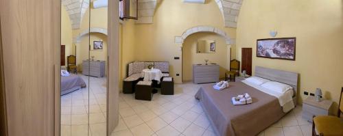 a large room with two beds and a bathroom at CASE VACANZA ZOE - SOLE in Serrano