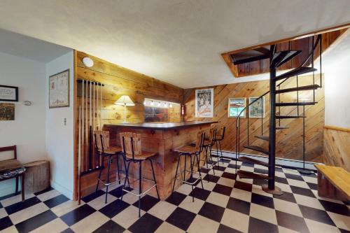 a bar in a room with a checkered floor at Old Kings Hideout in Wellfleet