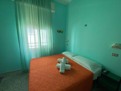 Un pat sau paturi într-o cameră la Albergo Acapulco
