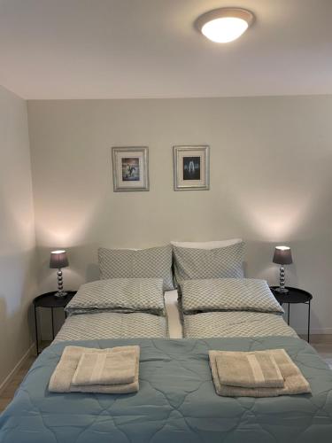 a bedroom with two beds with towels on them at Leilighet ved sjøen med strand in Porsgrunn