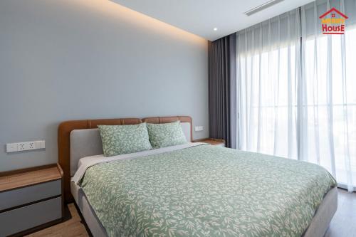 a bedroom with a bed and a large window at Merry House Harmony in Ðông Khê