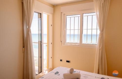 a bedroom with a window with a view of the ocean at Dos Mares Norte 414B in San Blas