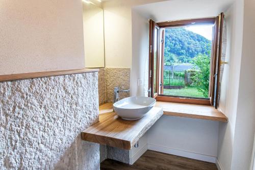 a bathroom with a sink and a window at Alloggio turistico Corte Grisi in Badia Calavena