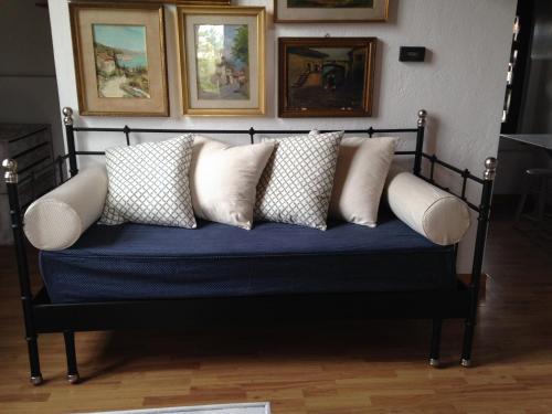 a blue couch with pillows on it in a room at Country House in Zerbolò