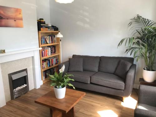 a living room with a couch and a fireplace at Falcon Cottage - 6 Guests, Sea Views in East Cowes