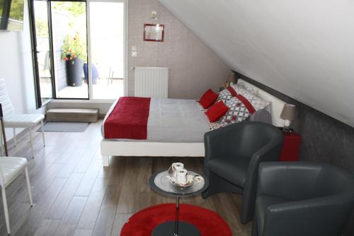 a bedroom with a bed and a chair and a table at MOR-HA-MARCH Chambres d'Hôtes in Sarzeau