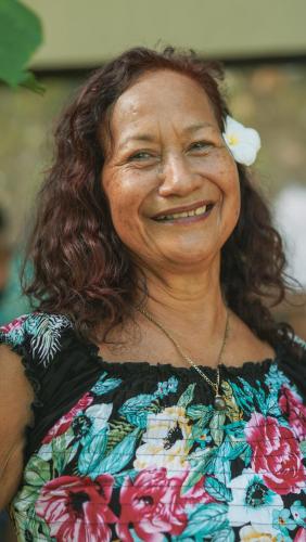 a woman with a flower in her hair smiling at Cabañas MANA NUI INN in Hanga Roa
