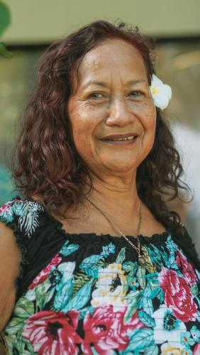 an older woman is smiling for the camera at Cabañas MANA NUI INN in Hanga Roa