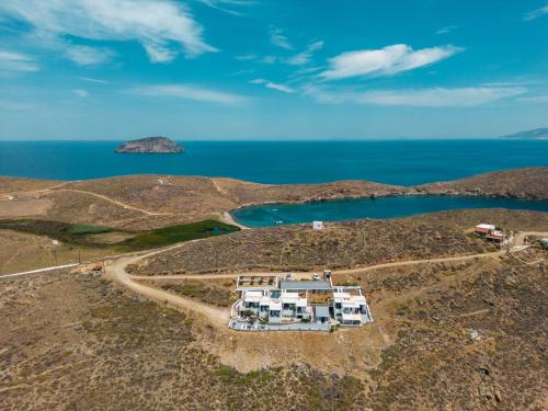 an aerial view of a house on a hill next to the ocean at Astrio Suites in Livadion