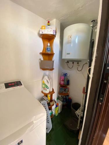 a small room with a bed and a room with a kitchen at Apartamento Los Marinos in Tías