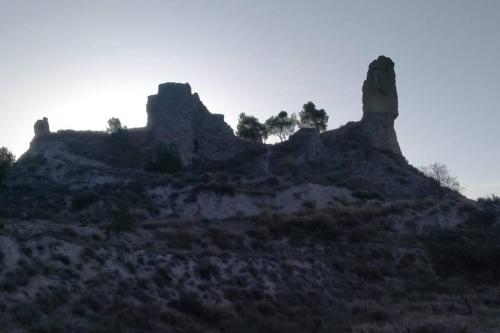 a rocky hill with trees on top of it at Cal Josep del Moto - Castelló de Farfanya in Castelló de Farfaña
