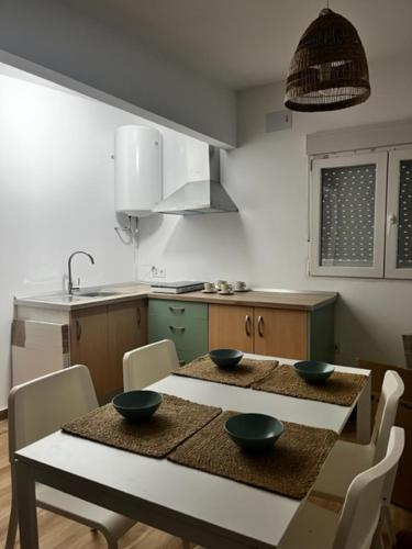 a kitchen with a table with three bowls on it at Casita de campo in Albacete