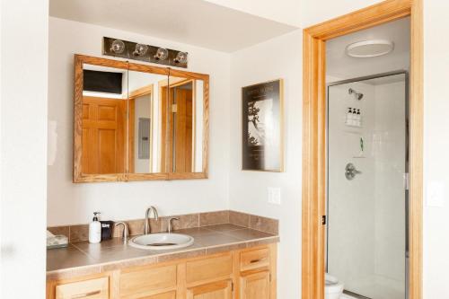 a bathroom with a sink and a mirror at Mod MTN Must - Steps from Shuttle - Silverthorne in Silverthorne
