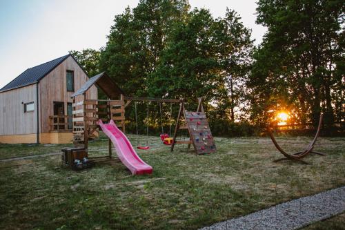 a playground with a slide and a play house at Widokówka Kaszuby in Mirachowo