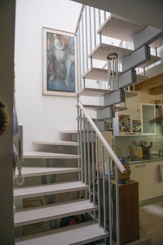 a staircase in a house with a painting on the wall at Apartment Bed&Bike in Arco