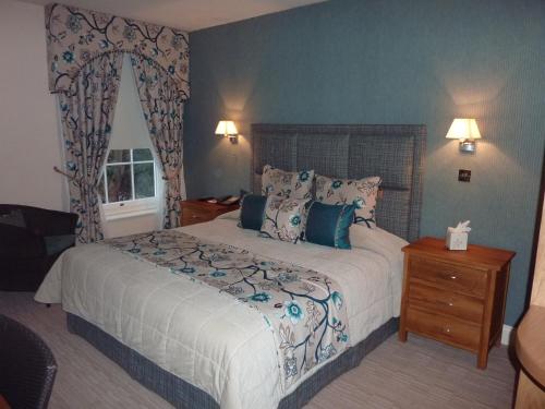 a bedroom with a large bed and a window at Orsett Hall in Orsett