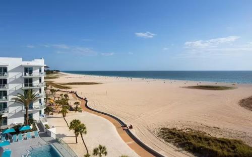 a view of the beach from the balcony of a resort at Waterfront Boat Lift Bungalow in St Pete Beach