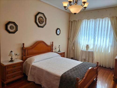 a bedroom with a bed and a large window at O NOSO FOGAR in Melide