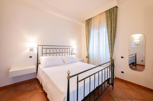 a bedroom with a bed and a window at DONNA FRANCA in Taormina