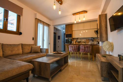 een woonkamer met een bank en een tafel bij Maria Ireon Apartment 1 with hot-tube in Iraion