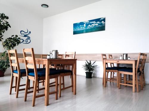 a dining room with a wooden table and chairs at Hotel Pallone in Balatonfüred