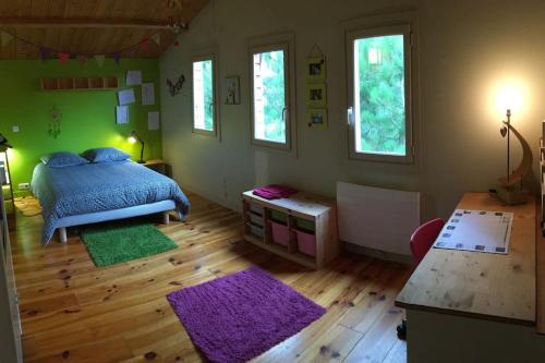 - une chambre avec un lit, du parquet et des fenêtres dans l'établissement La Maison de l'Aérogrange, à Biscarrosse
