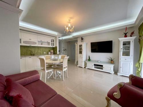 a living room with a red couch and a table at Lux apartament in Focşani