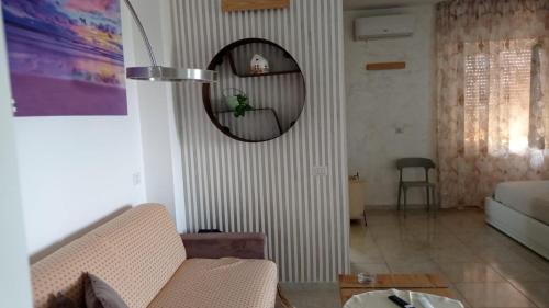 a living room with a couch and a mirror at Bed&breakfast Albysuite in Termoli