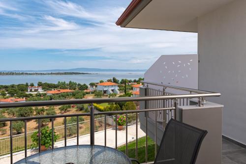a balcony with a view of the water at THEA Luxury Apartments in Vourvourou