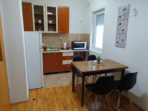 a kitchen with a table and chairs in a room at Finesi apartments 3 in Ohrid