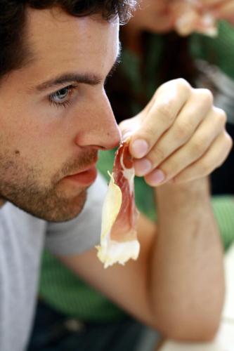 a man eating a piece of food in his mouth at Albergo dell'Agenzia in Bra