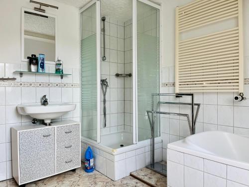 a bathroom with a shower and a sink and a tub at Ferienhaus Kyritz Gantikow in Mechow