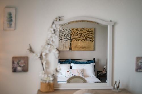 a mirror reflection of a bed in a bedroom at Drita Studios & Apartments in Svoronata