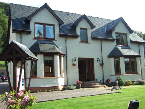 a white house with a roof at Glengyle Guest House in Fort William