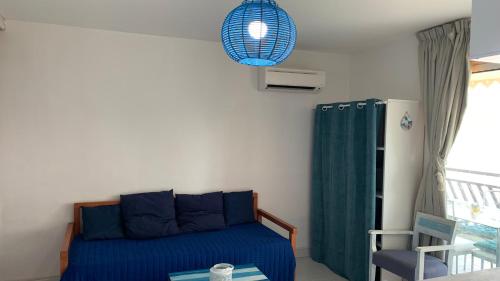 a bedroom with a bed and a pendant light at Bluewave in Saint-François