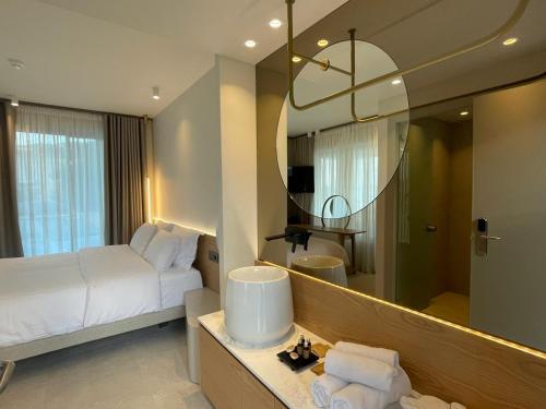 a hotel room with a bed and a mirror at Balance Accommodation in Stavros