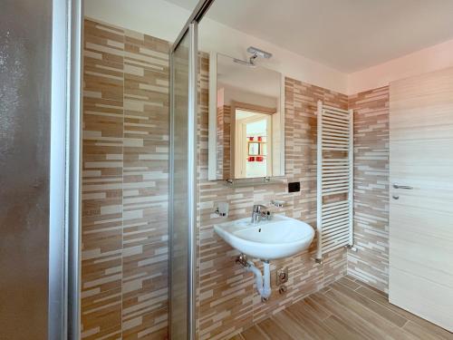 a bathroom with a sink and a shower at Chalet I Clus in Livigno