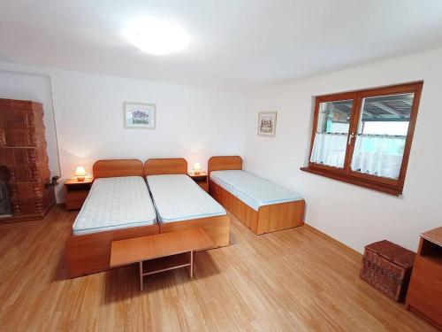 a room with two beds and a window at Private House with Garden in Mislea